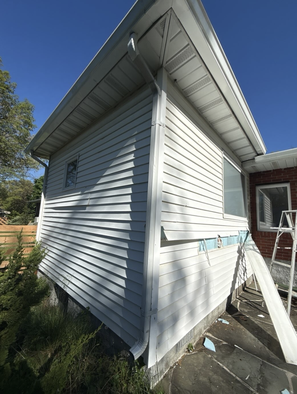 Before: cracked and broken horizontal siding in need of replacement