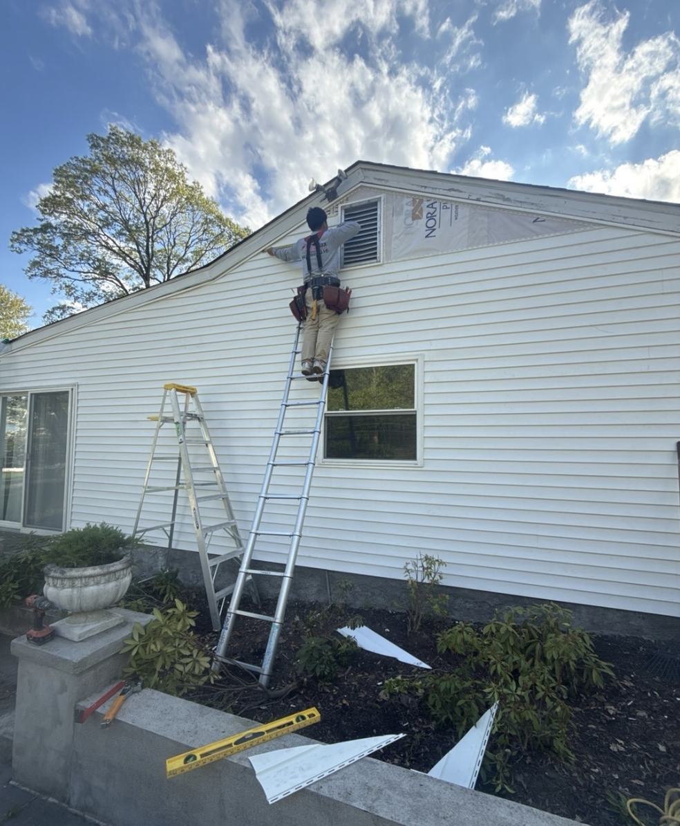 DuraMax team assessing siding condition on site