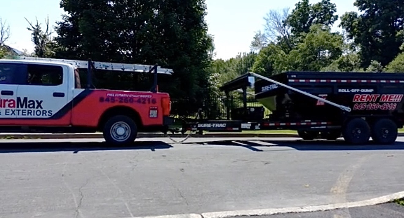 DuraMax dumpster on wheels on a job site