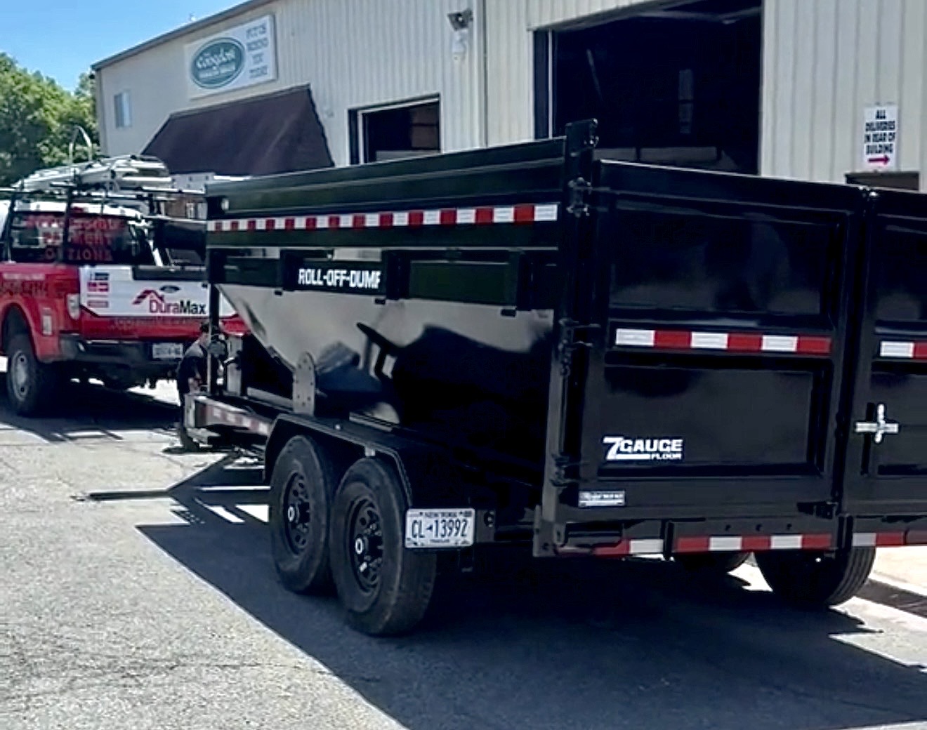 DuraMax dumpster on wheels on a job site