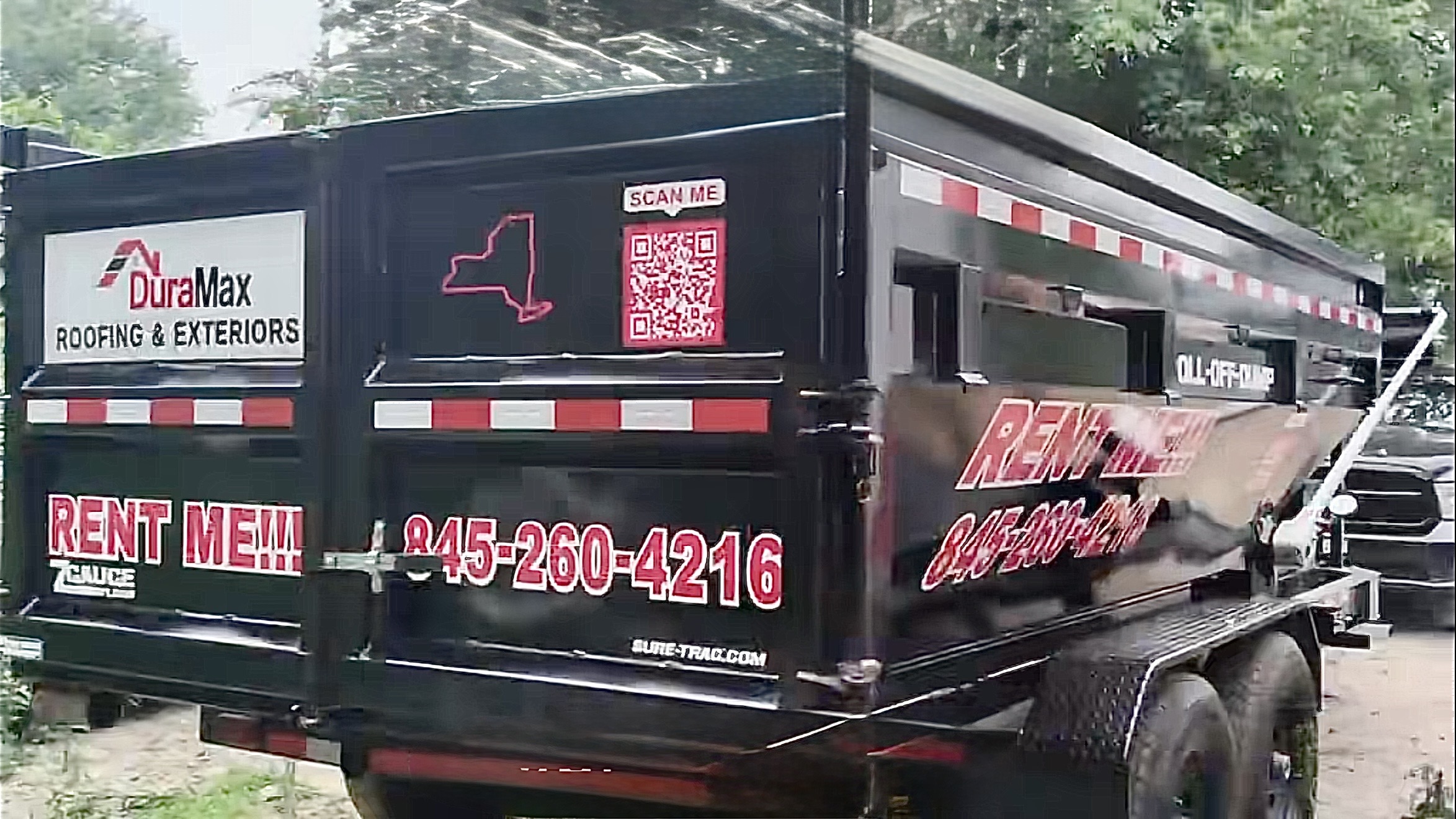 DuraMax dumpster on wheels on a job site